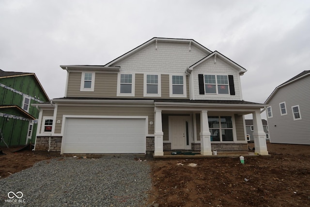 craftsman house featuring covered porch and a garage