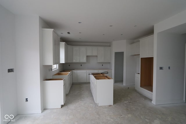 kitchen with white cabinets and a center island