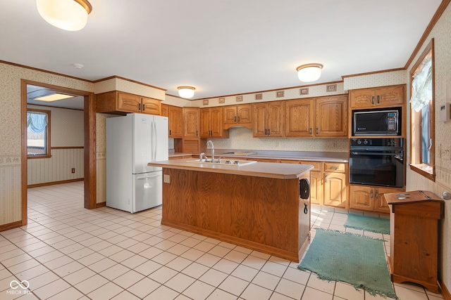 2831 S Hixon Rd S, Montezuma, IN 47862 - kitchen with black oven, freestanding refrigerator, wallpapered walls, built in microwave, and crown molding