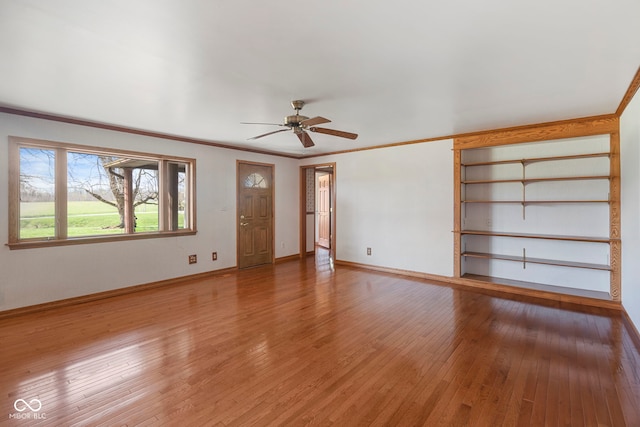 2831 S Hixon Rd S, Montezuma, IN 47862 - unfurnished living room with light wood-style flooring, ceiling fan, baseboards, and ornamental molding