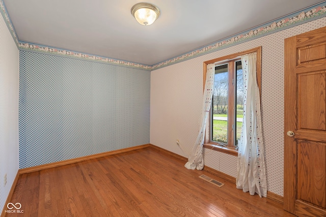2831 S Hixon Rd S, Montezuma, IN 47862 - unfurnished room featuring light wood-style flooring, baseboards, and wallpapered walls