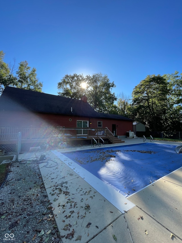 view of swimming pool featuring a patio and a deck