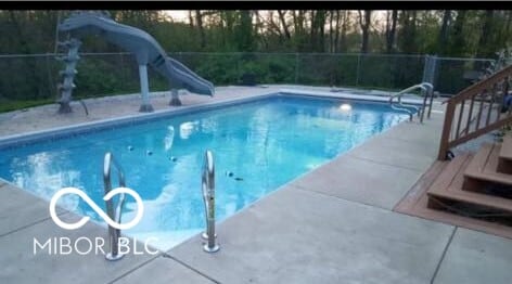 view of swimming pool featuring a water slide