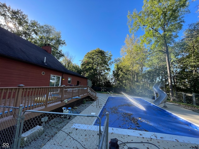 view of swimming pool with a wooden deck