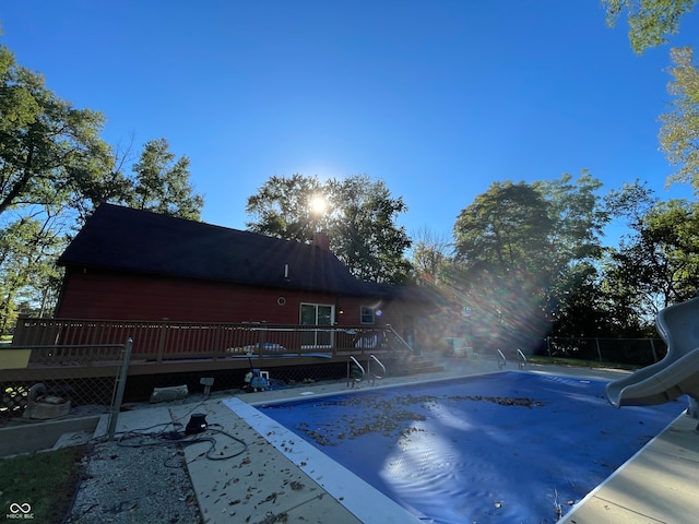 view of swimming pool featuring a patio and a deck