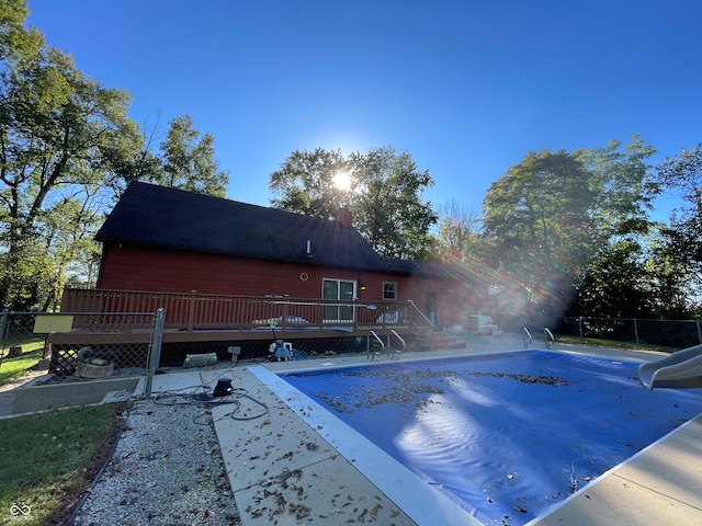 view of pool featuring a wooden deck and a water slide