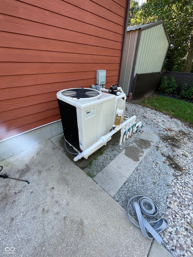 exterior details with central air condition unit and wood walls