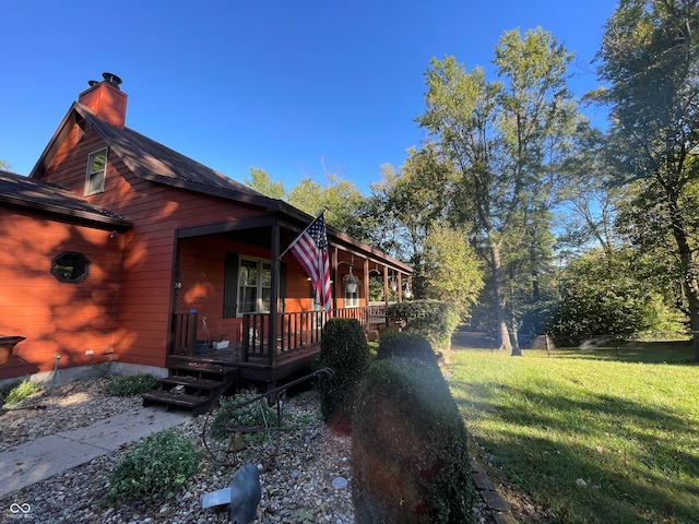 view of side of property with a lawn