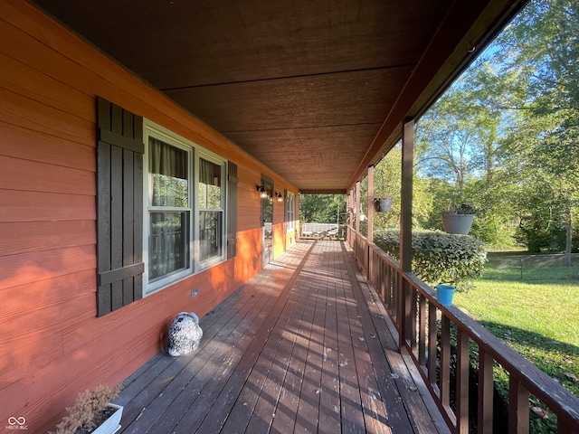 wooden terrace with a yard