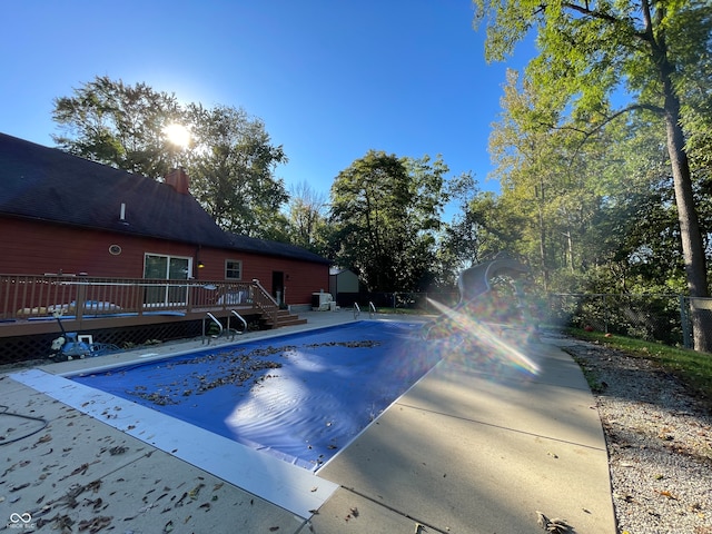 view of pool with a wooden deck and a patio