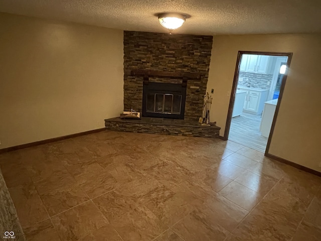 unfurnished living room with tile patterned floors, a textured ceiling, and a fireplace