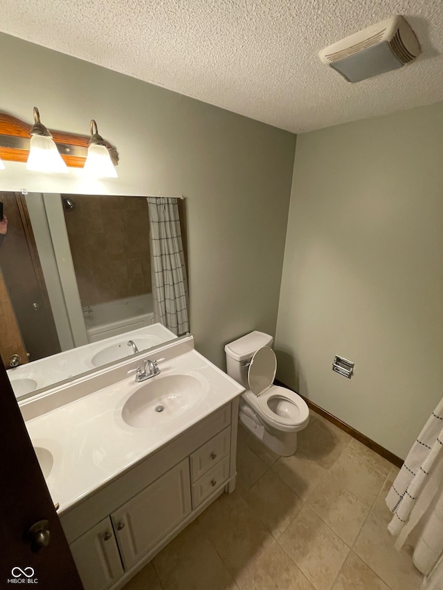 full bathroom with toilet, tile patterned flooring, separate shower and tub, vanity, and a textured ceiling