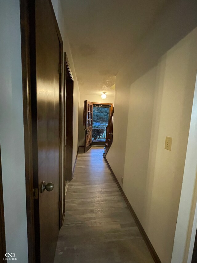 corridor with wood-type flooring