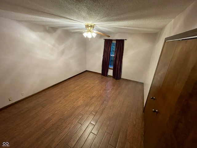 unfurnished room with hardwood / wood-style floors, a textured ceiling, and ceiling fan