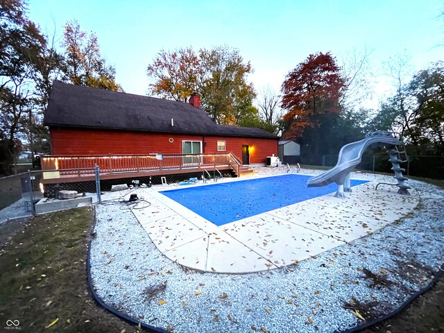 view of swimming pool featuring a wooden deck and a patio area