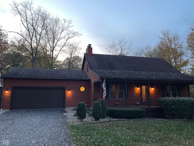 view of front of property featuring covered porch and a garage