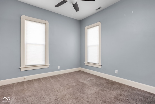 carpeted spare room with plenty of natural light and ceiling fan