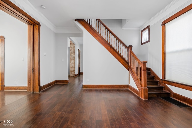 staircase with hardwood / wood-style flooring and ornamental molding