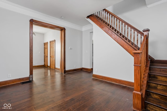 stairs with crown molding and wood-type flooring