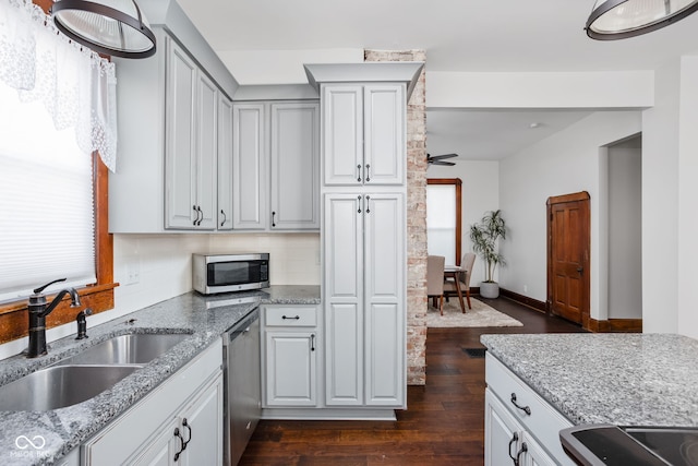 kitchen featuring a healthy amount of sunlight, stainless steel appliances, sink, and dark hardwood / wood-style flooring