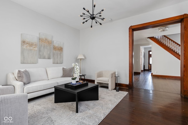 living room with a chandelier and dark hardwood / wood-style floors