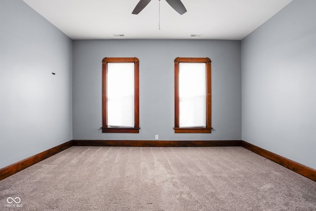 spare room featuring ceiling fan and carpet flooring