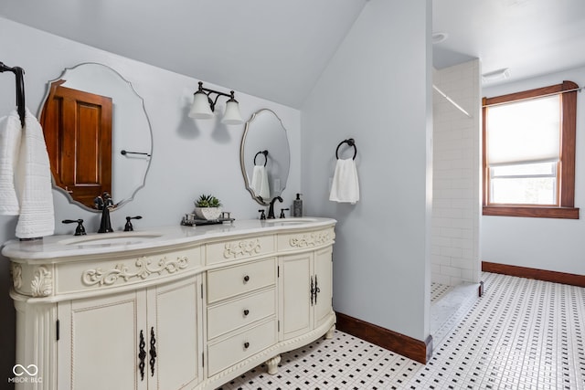 bathroom with vanity, walk in shower, vaulted ceiling, and tile patterned flooring