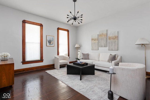 living room with dark hardwood / wood-style flooring and a chandelier