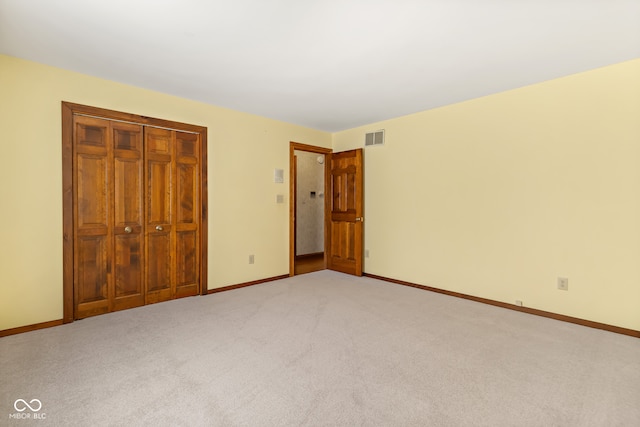 unfurnished bedroom featuring carpet and a closet