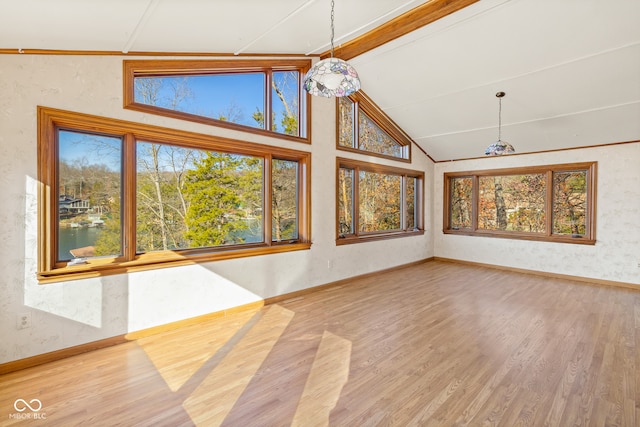 unfurnished living room with a chandelier, hardwood / wood-style floors, and lofted ceiling with beams