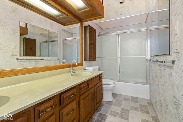 full bathroom with toilet, vanity, and combined bath / shower with glass door