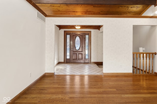 entrance foyer with hardwood / wood-style floors, beam ceiling, and wood ceiling