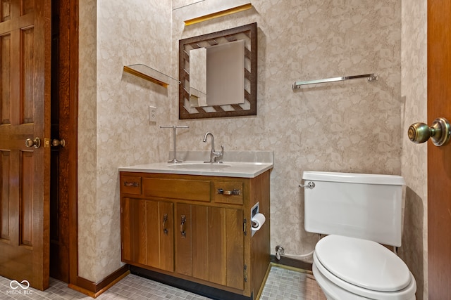 bathroom featuring toilet, vanity, and tile patterned floors