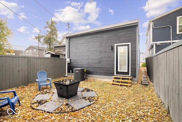 rear view of property with central air condition unit and a patio