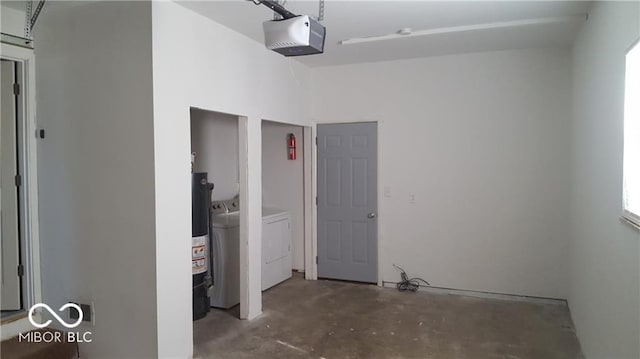 garage with a garage door opener and washer and dryer