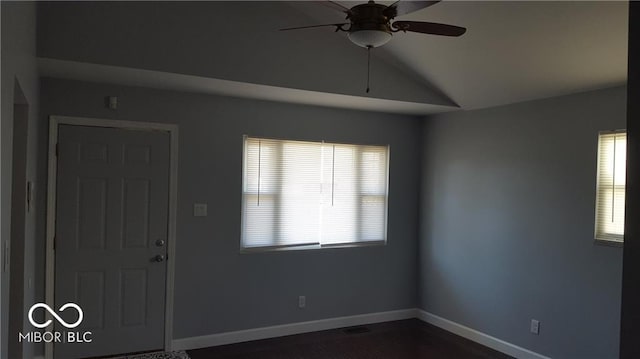 empty room with ceiling fan and vaulted ceiling