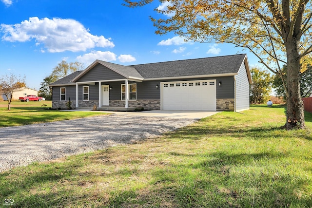 view of front of property with a porch, a front lawn, and a garage