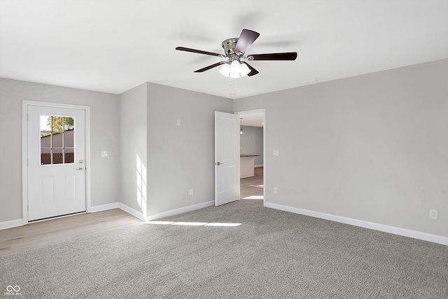 unfurnished room featuring ceiling fan and light colored carpet