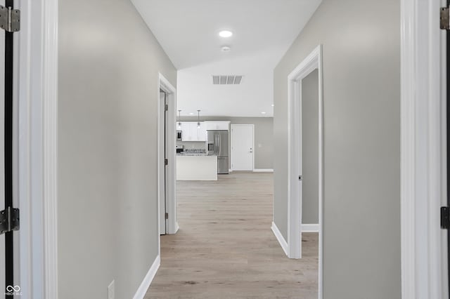 corridor with light hardwood / wood-style flooring