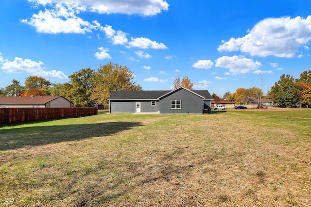 back of property featuring a yard