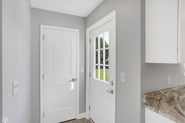 7234 N Christopher Ln, Fairland, IN 46126 - doorway with light wood-type flooring, baseboards, and a healthy amount of sunlight