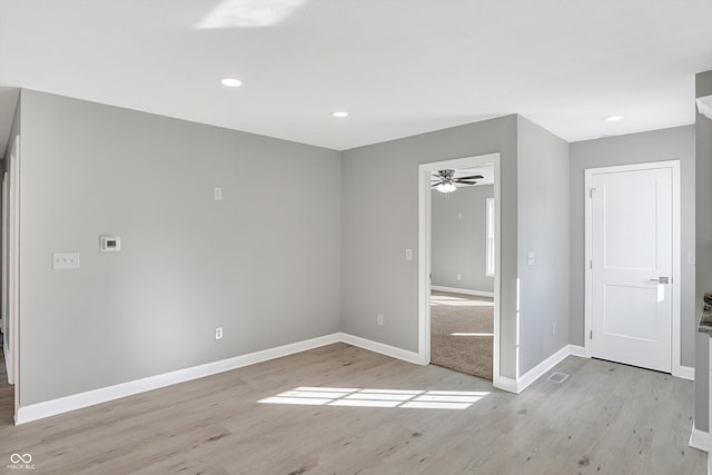 spare room with light hardwood / wood-style floors and ceiling fan