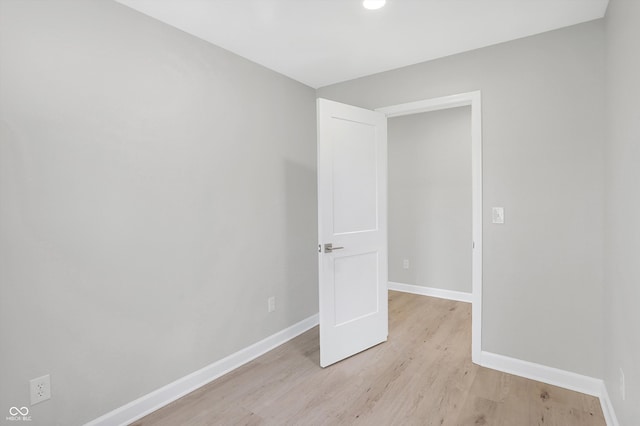 spare room featuring light hardwood / wood-style flooring