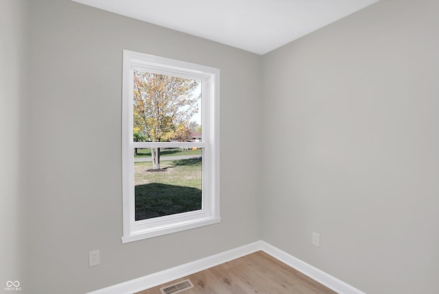 empty room with hardwood / wood-style flooring