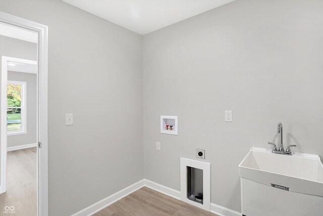 7234 N Christopher Ln, Fairland, IN 46126 - clothes washing area with light wood finished floors, hookup for an electric dryer, baseboards, washer hookup, and laundry area
