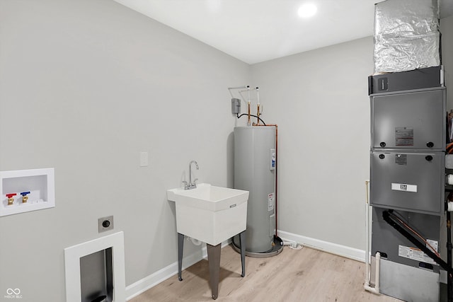 laundry room with electric water heater, washer hookup, light hardwood / wood-style flooring, hookup for an electric dryer, and sink