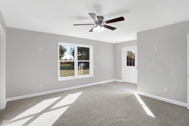 7234 N Christopher Ln, Fairland, IN 46126 - carpeted empty room with baseboards, ceiling fan, and a healthy amount of sunlight