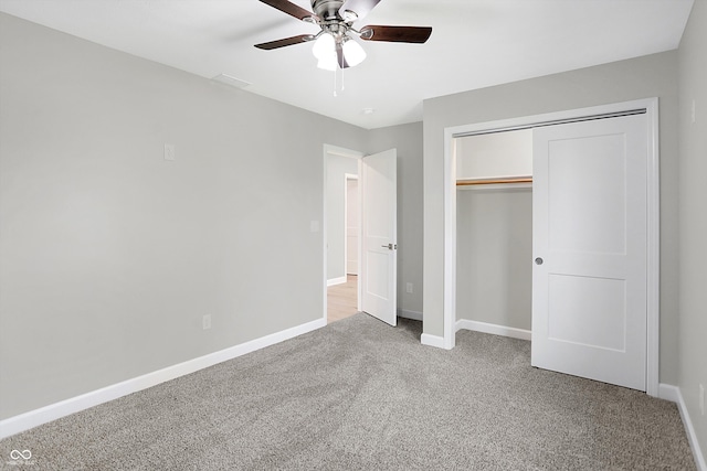 unfurnished bedroom featuring a closet, light colored carpet, and ceiling fan