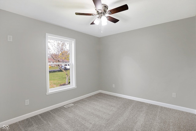 unfurnished room featuring ceiling fan and carpet