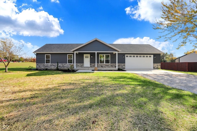 view of front facade featuring a front lawn, covered porch, and a garage